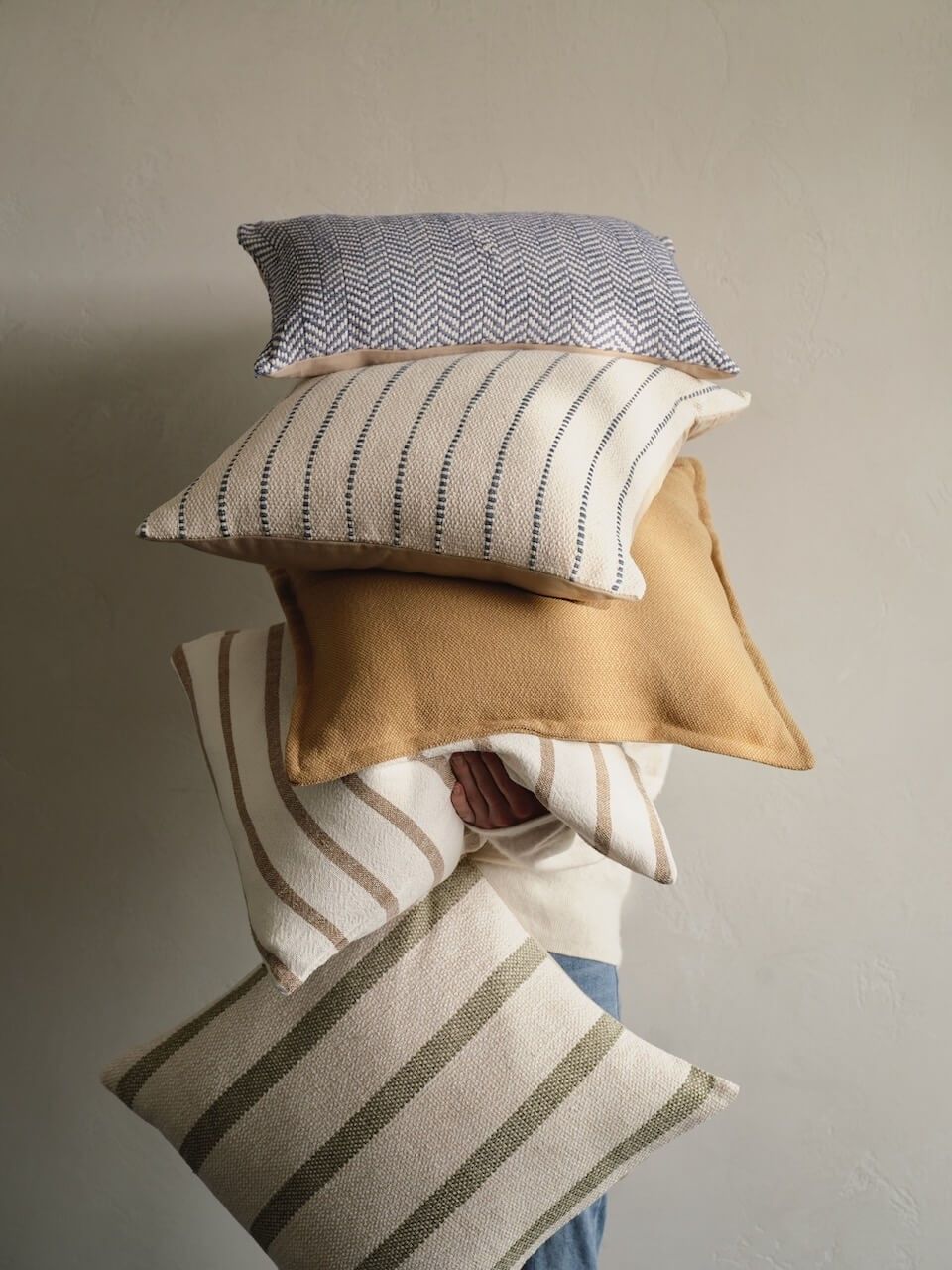 Soft blankets and cushions styled in a relaxed home setting